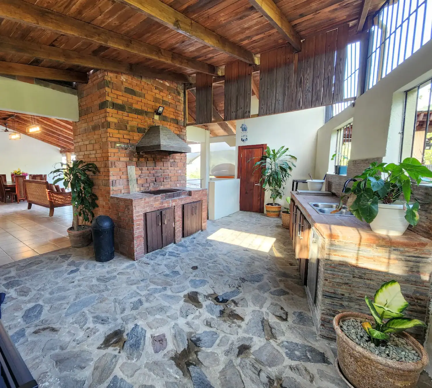 The covered BBQ kitchen with its brick grill