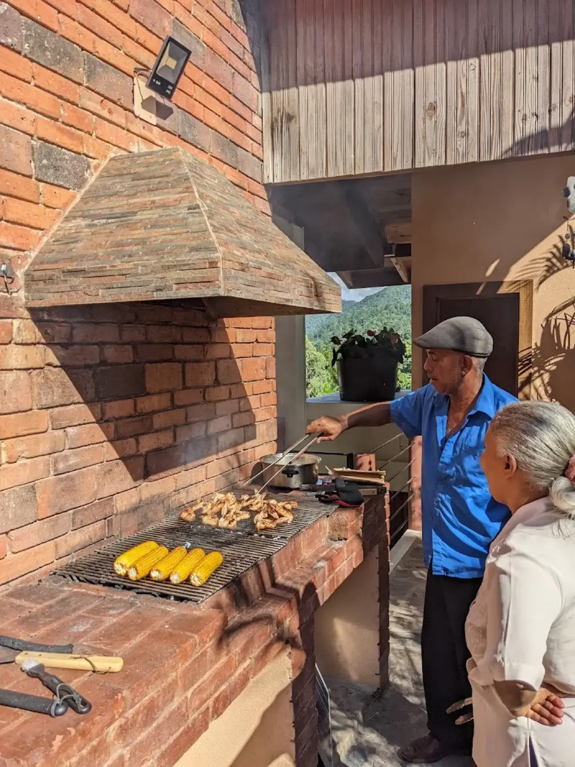 Grilling chicken and corn on the brick BBQ