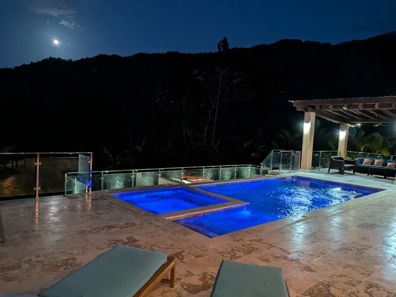 The pool and jacuzzi under a full moon
