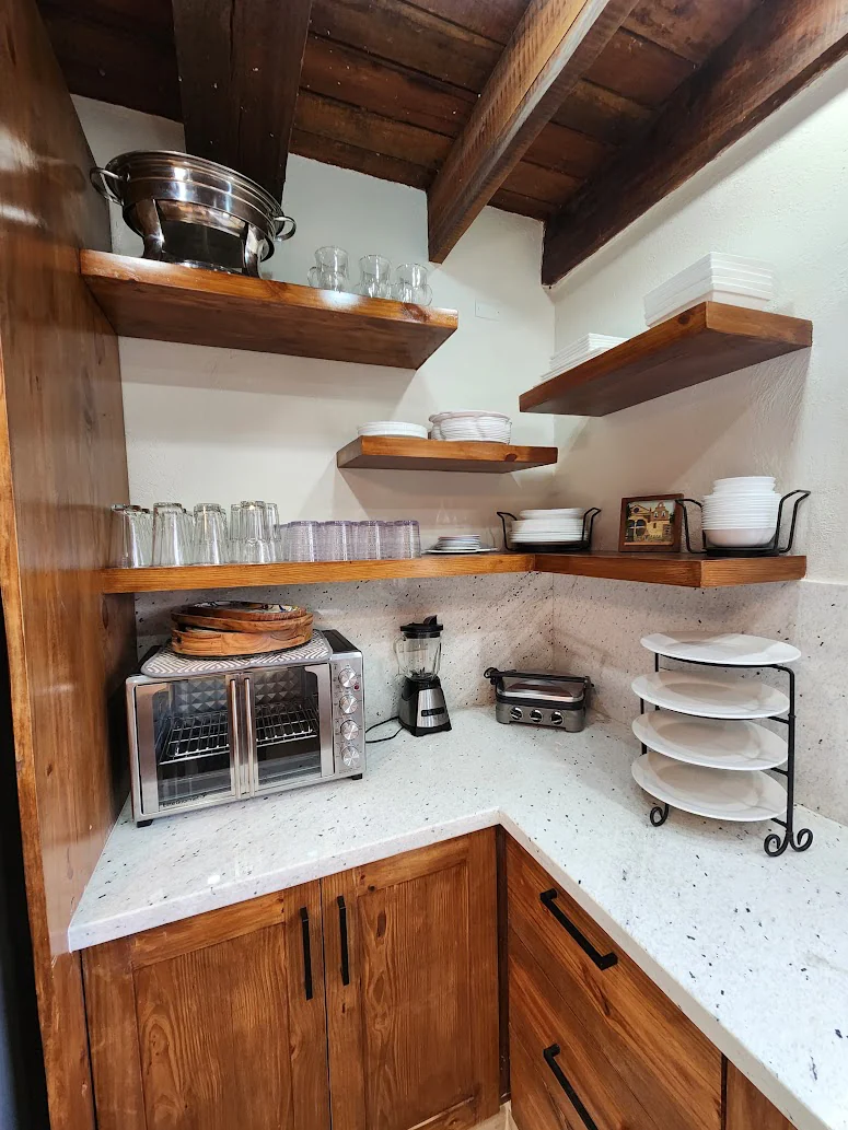 The prep corner, with open shelving and a countertop oven