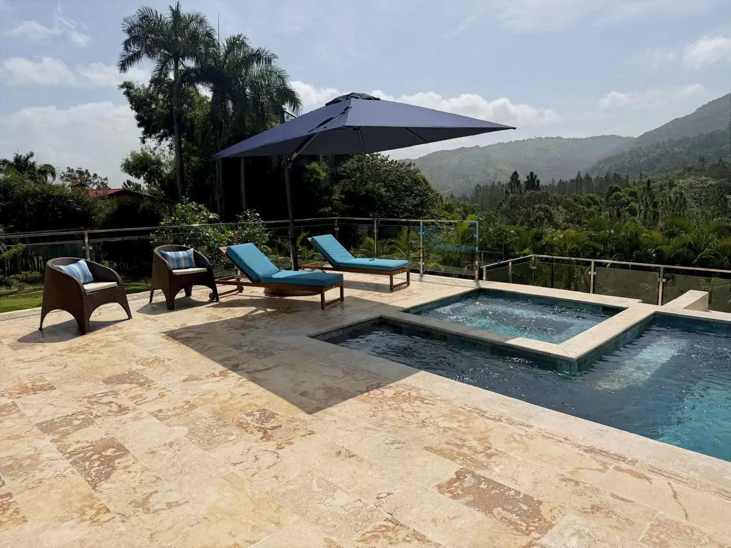 The pool deck and mountain views by day
