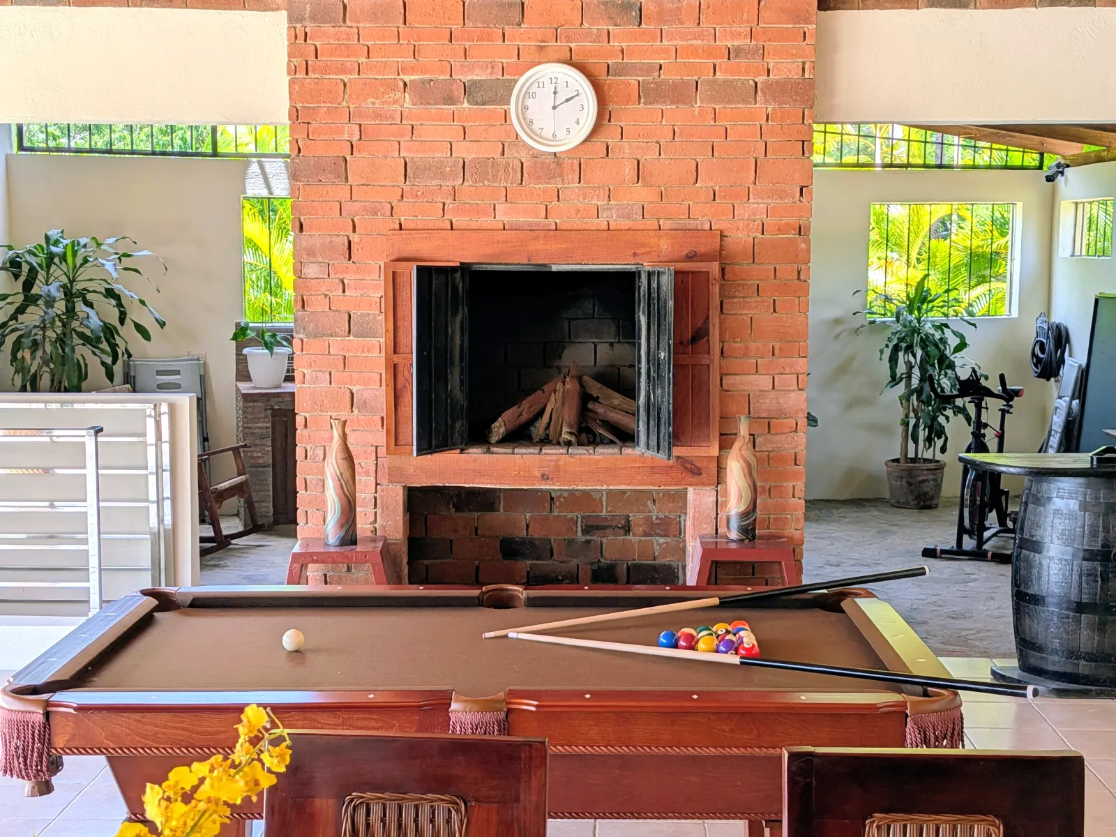 The pool table in the covered lounge, by the fireplace